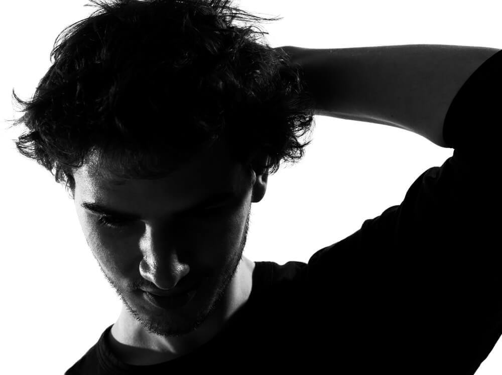 How to be happy: young man sad silhouette in studio isolated on white background