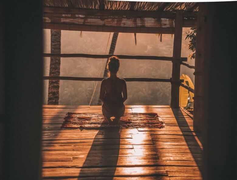 Woman meditating on deck