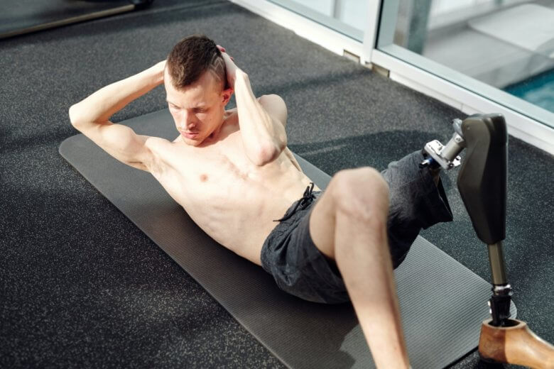 Resilience: One-legged man doing situps